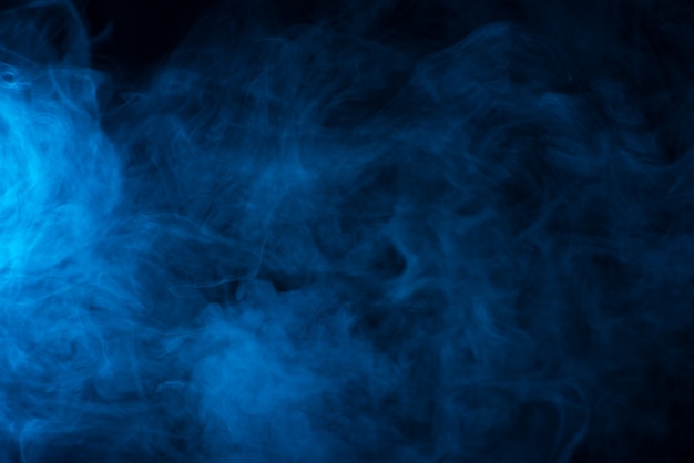 Premium Photo | Blue smoke texture on a black background