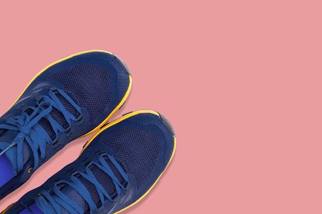 Premium Photo | Blue sneakers on a pink background