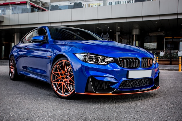 Blue sport sedan parked in the yard. Free Photo