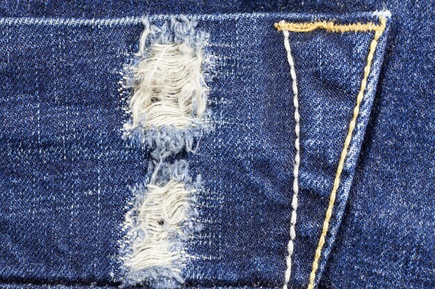 Premium Photo | Blue torn denim jeans texture