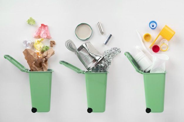 Premium Photo | Blue trash bins and assorted garbage on grey background ...