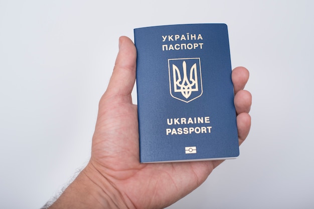 Premium Photo | Blue ukrainian passport in a man's hand. white