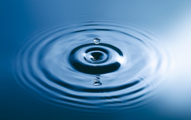 Premium Photo | Blue water drop falling down and circles wave.