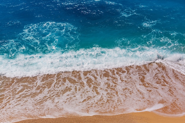 Premium Photo | Blue wave on the beach. blur background and sunlight ...