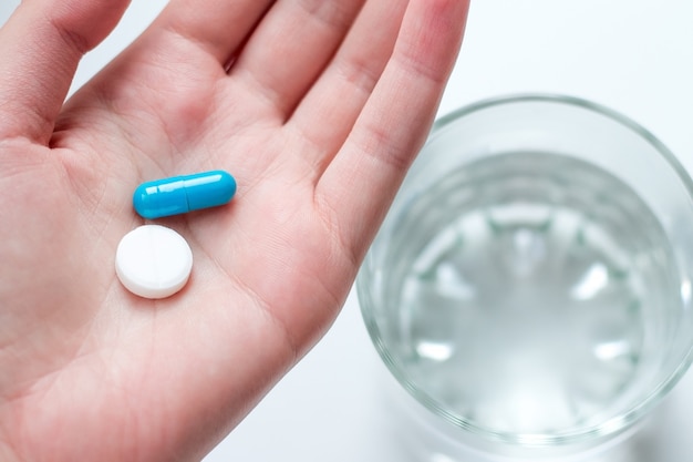 premium-photo-blue-and-white-pill-capsule-on-the-female-palm