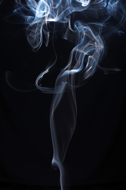 Premium Photo | Blue and white smoke on black background