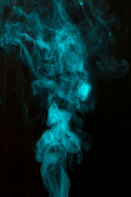 Blue wispy smoke spread on black background | Free Photo