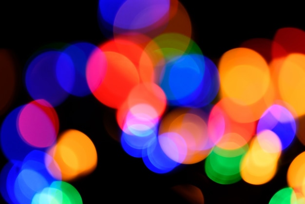 Premium Photo | Blurred colorful circular facular on dark background.