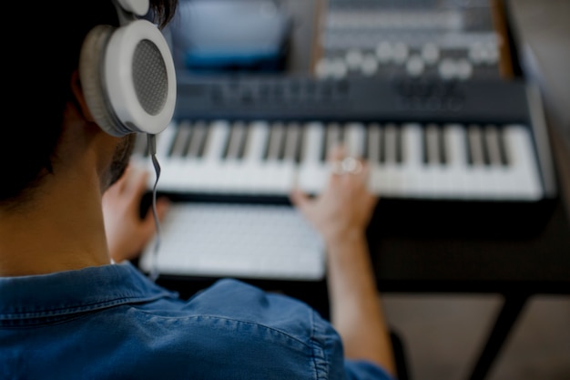 premium photo blurred focus close up male music arranger hands composing song on midi piano and audio equipment in digital recording studio man produce electronic soundtrack or track in project at home https www freepik com profile preagreement getstarted 8809542