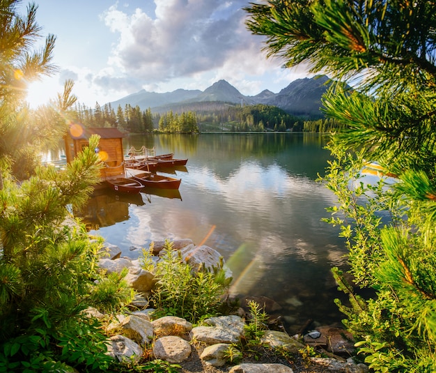 Premium Photo | Boat on the dock surrounded mountains. fantastic ...