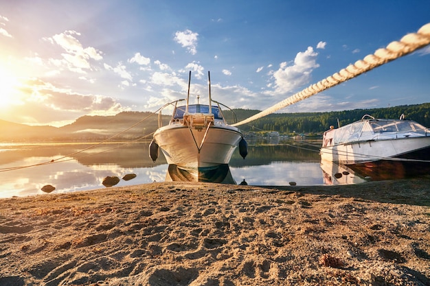 Premium Photo | Boat on lake at background of sunset summer day