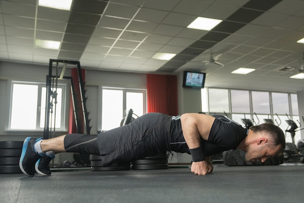 Premium Photo | Bodybuilder working out and doing push ups on fists at ...