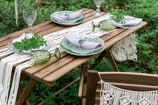 Premium Photo | Boho style wedding reception dinning table with macrame  tablecloth, decoration on a rustic wooden table