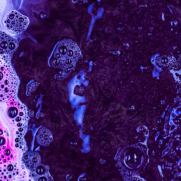 Boiling black liquid with blue foam Free Photo