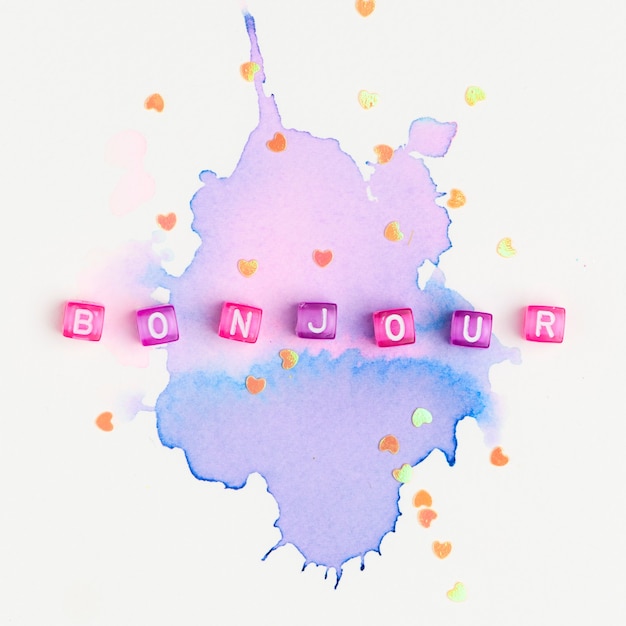Bonjour beads word typography on purple watercolor Free Photo
