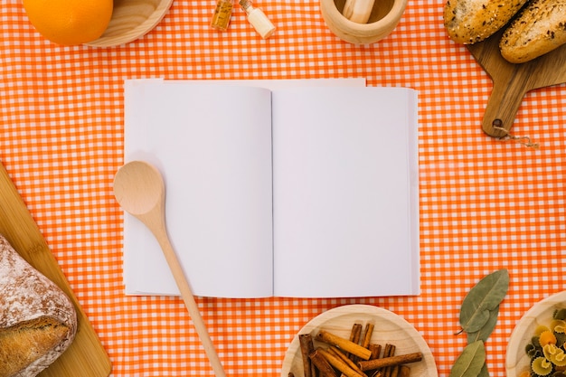 Download Book mockup with wooden spoon and bread | Free Photo