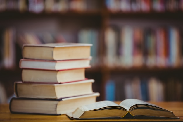 Books on desk in library | Premium Photo