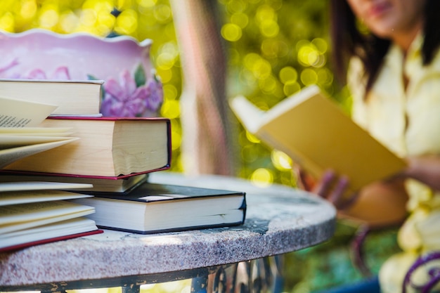 Free Photo | Books on table and woman reading