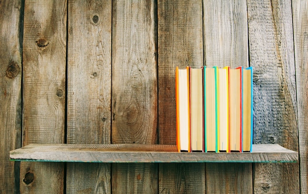 Premium Photo Books On Wooden Shelf On Wooden Table