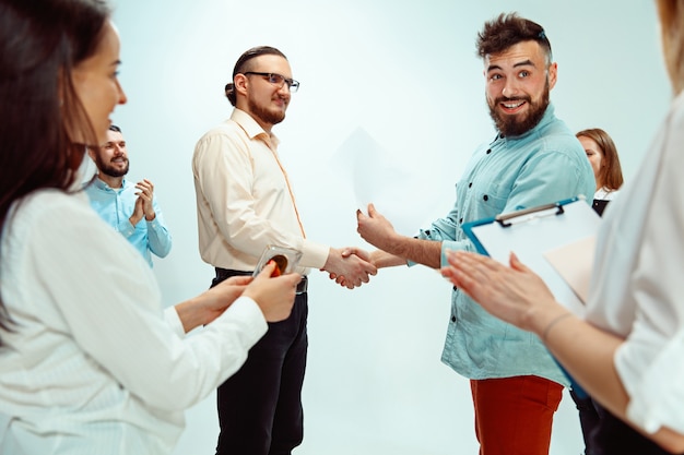 Premium Photo | Boss approving and congratulating young successful employee