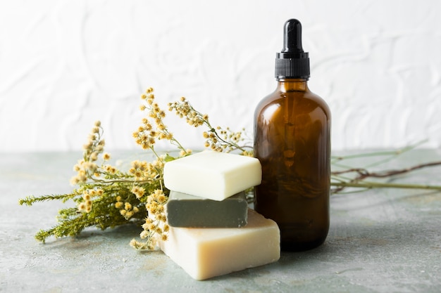 Premium Photo | Bottle for skincare oils next to different soaps