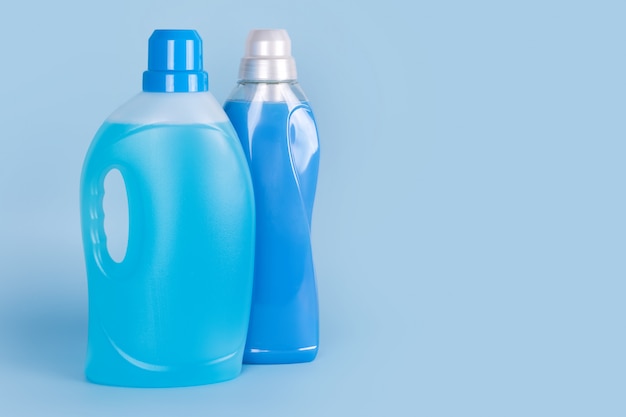 Premium Photo | Bottles of detergent and fabric softener on blue background