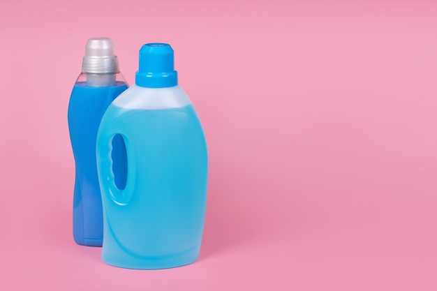 Premium Photo | Bottles of detergent and fabric softener on pink background