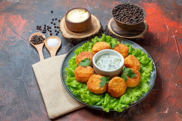 Free Photo | Bottom view chicken nuggets lettuce on plate black pepper ...