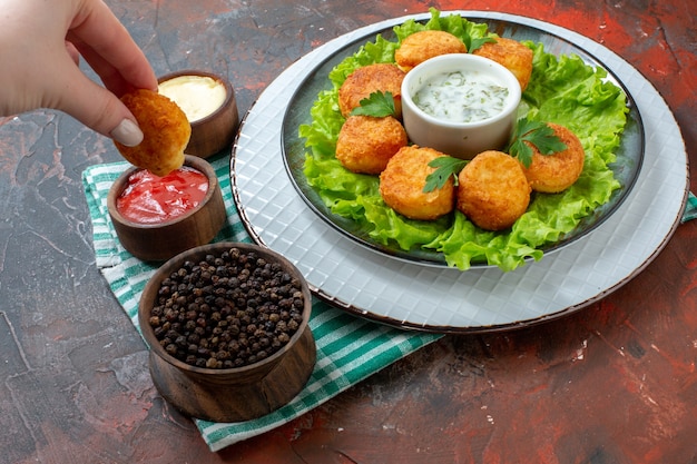 Free Photo | Bottom view chicken nuggets lettuce and sauce on plate ...