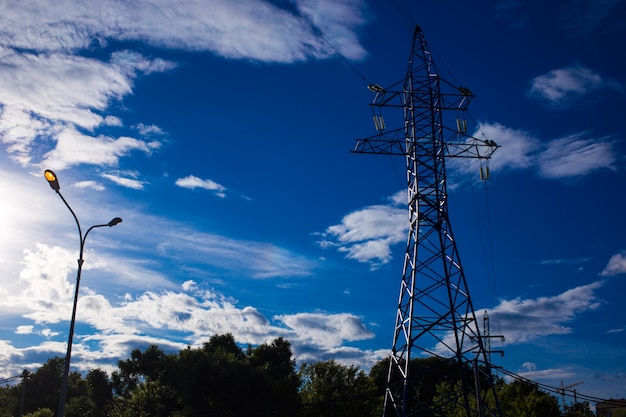 Bottom view of the tower of power grids on blue sky background, high voltage, electricity concept Premium Photo