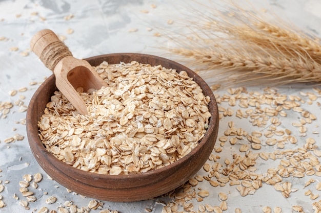 Premium Photo | Bottom view wooden bowl with oats wheat spikes ...