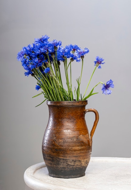 Premium Photo | Bouquet of blue cornflowers in vase on the table