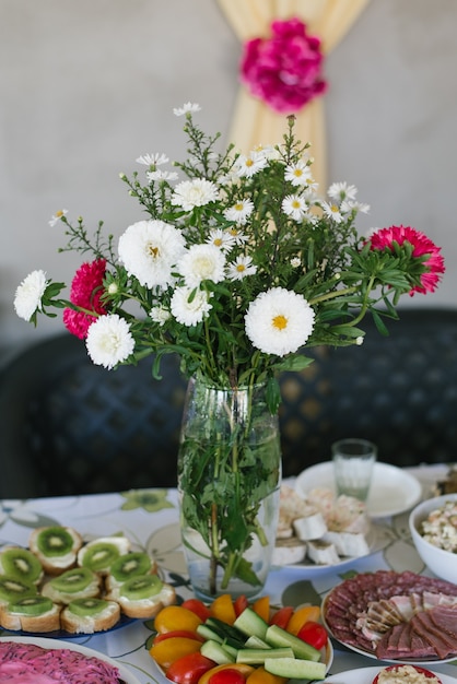 Premium Photo | A bouquet of homemade asters in a glass vase in the ...