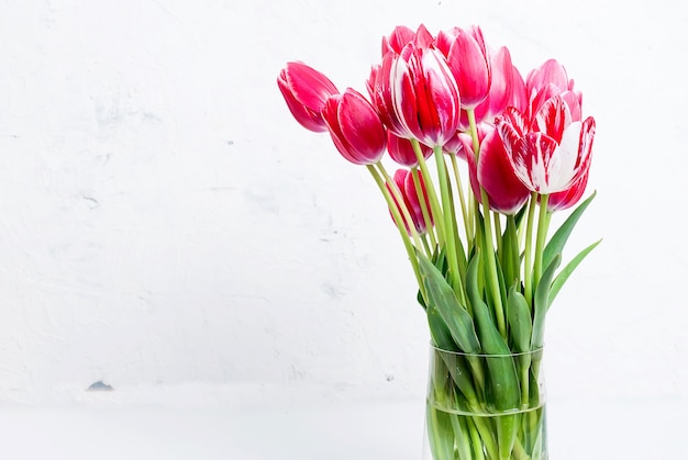 Premium Photo | Bouquet of red tulips in a vase