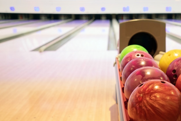 Premium Photo | Bowling balls on a stack with the bowling alley background