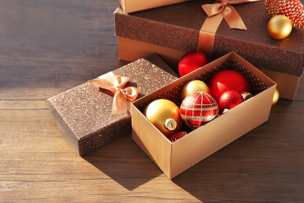 Premium Photo Box with christmas toys on wooden background