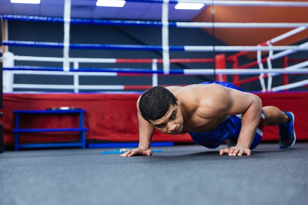 Premium Photo | Boxer doing push ups near boxing ring