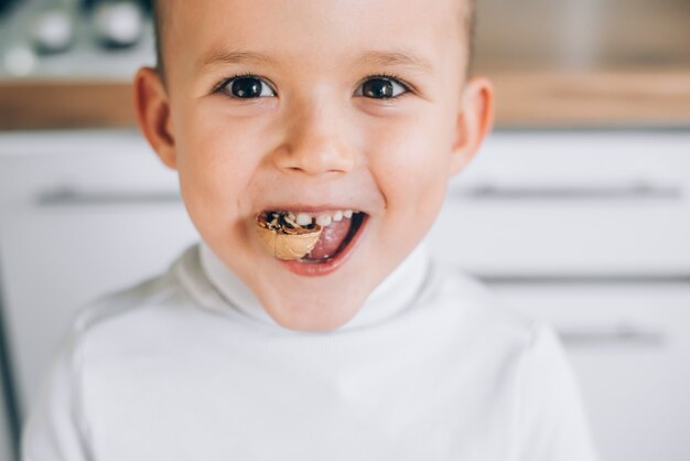 Premium Photo | A boy child tries to crack a walnut showing healthy ...