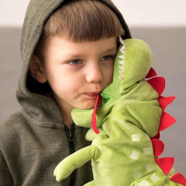 Premium Photo | Boy in dinosaur costume with toy