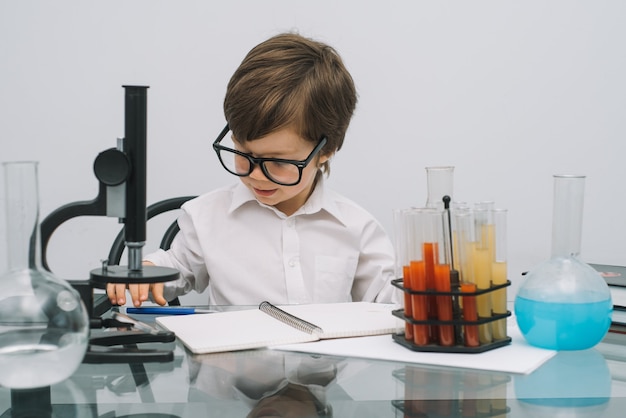 Premium Photo | A boy doing experiments in the laboratory