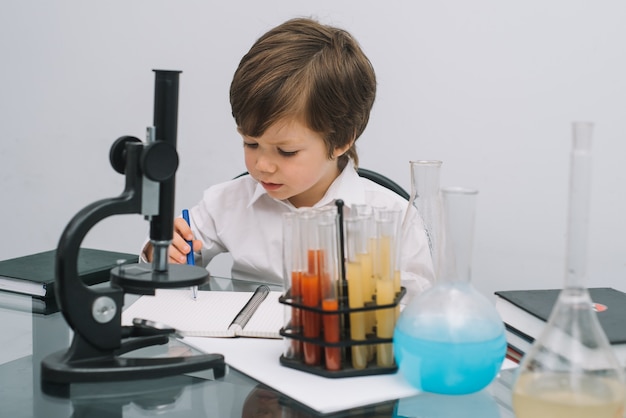 Premium Photo | A boy doing experiments in the laboratory