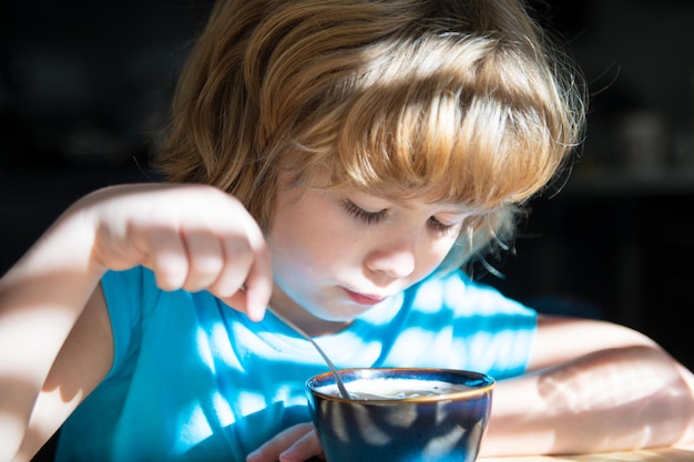 Premium Photo | Boy eats soup. healthy nutrition for children. home ...