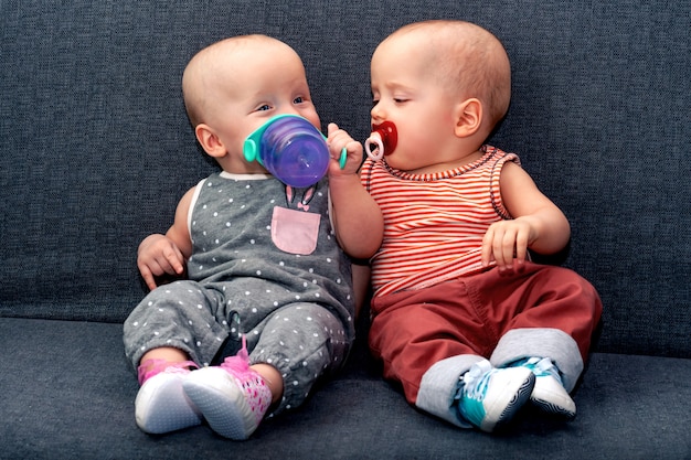 Twins sitting on a sofa. | Photo: Freepik