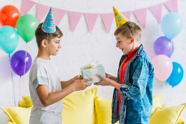 free-photo-boy-giving-birthday-gift-to-his-friend