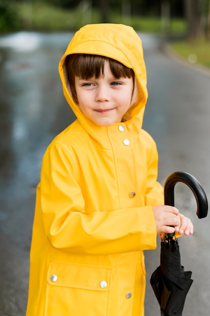 Free Photo | Boy holding a closed umbrella