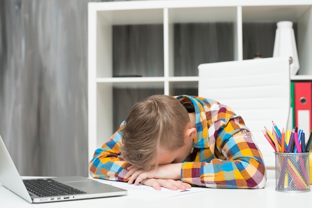 Boy Sleeping In Front Of Laptop On Desk Photo Free Download