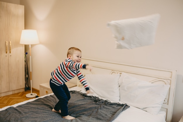 Premium Photo | Boy throwing a pillow away