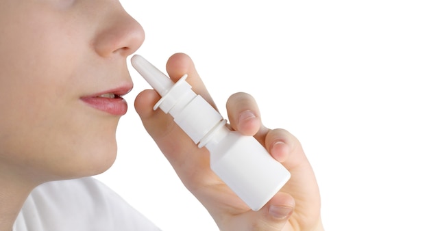 Premium Photo | A boy uses a nasal spray isolated . teenager using ...