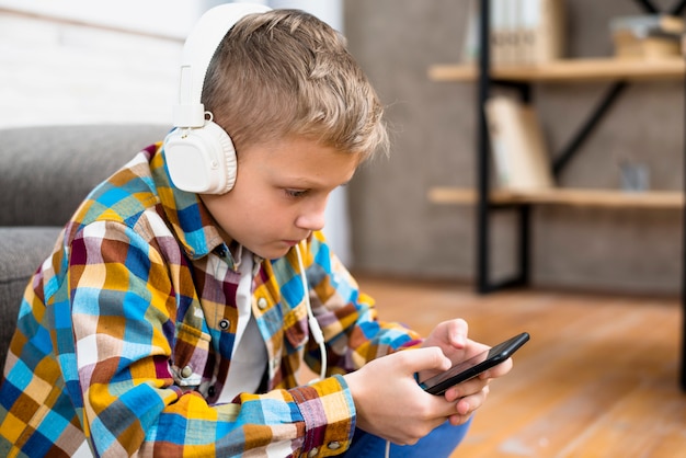 Free Photo | Boy with headphones using smartphone