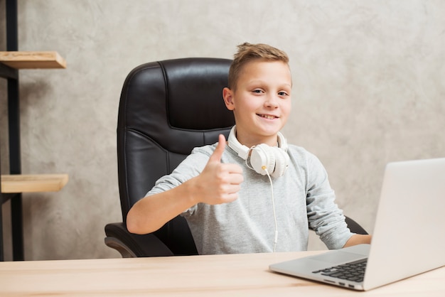 Boy with laptop in office Free Photo